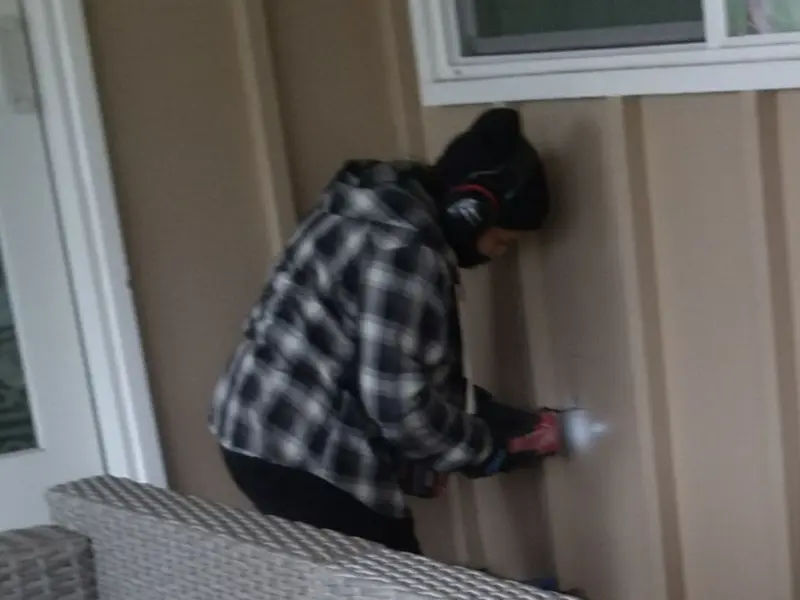 Professional electrician installing an exterior outlet in St. Cloud