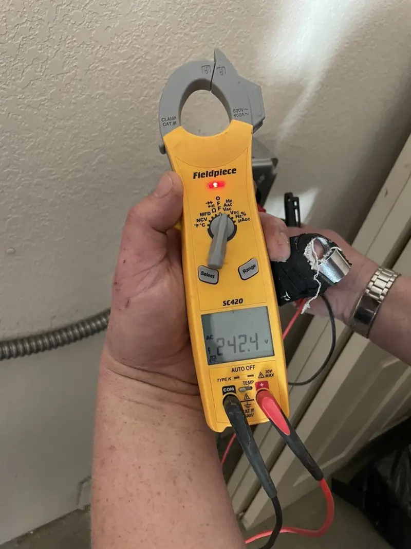 Voltage testing with clamp meter during Whole House Surge Protector in St. Cloud
